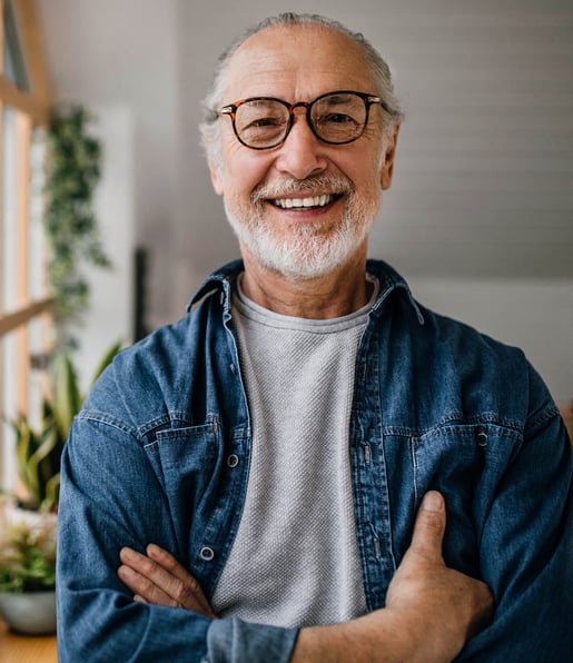 Man with Beard in Glasses in Home with Arms Crossed